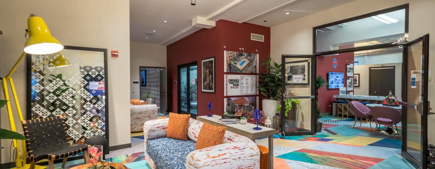 a spacious lounge with chairs and carpet
